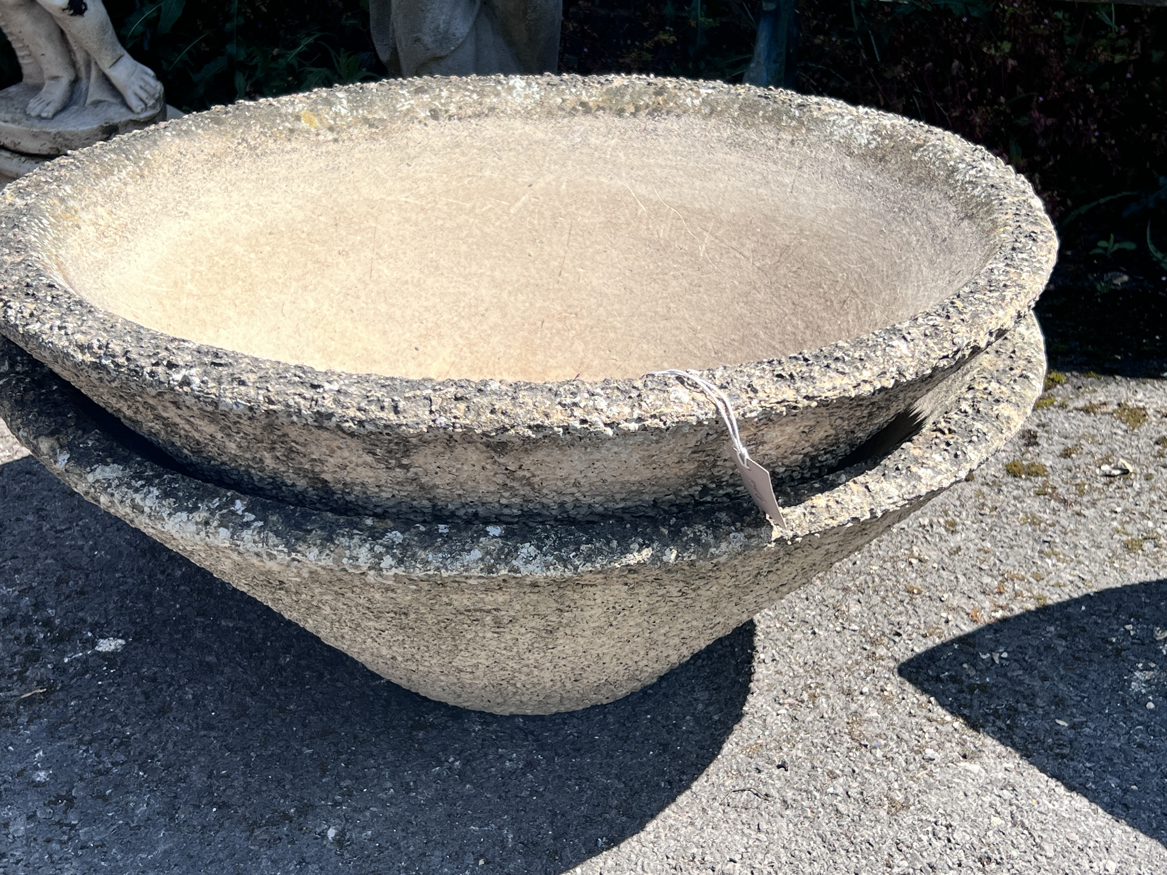 A pair of circular reconstituted stone conical planters, diameter 78cm, height 29cm